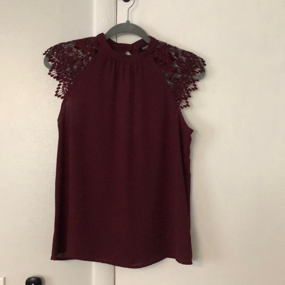 Beautiful blouse with lace cap sleeves. NWOT. Back has a cut out. Very pretty.